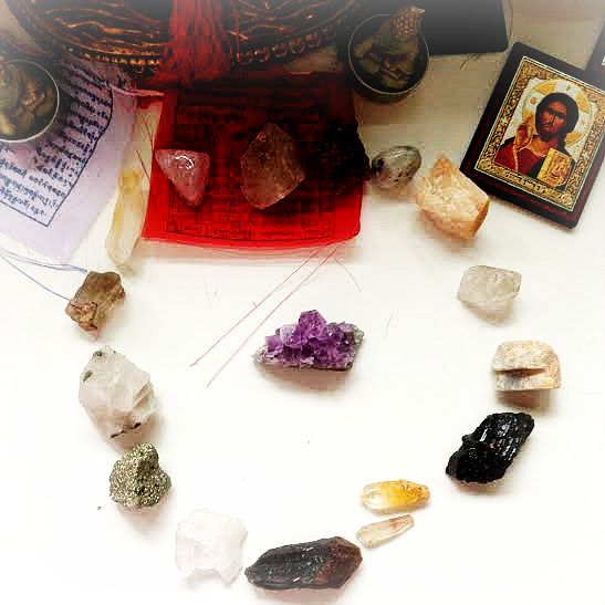 crystals being cleansed by unpolished, uncut amethyst, post-tingsha bells cleansing